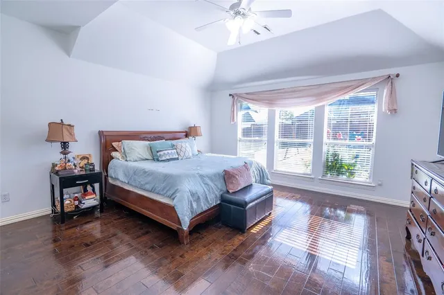 a bedroom with a bed and a large window