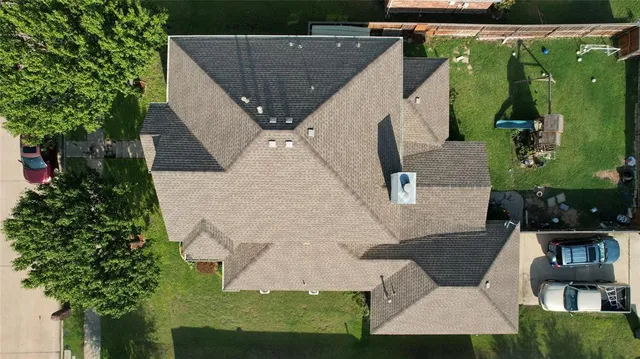 an aerial view of a house with a yard