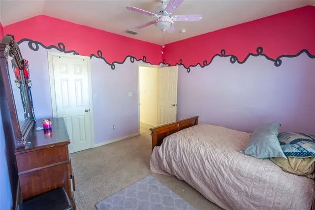 a bedroom with a bed and a mirror