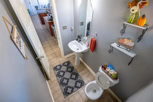 a bathroom with a sink mirror and toilet