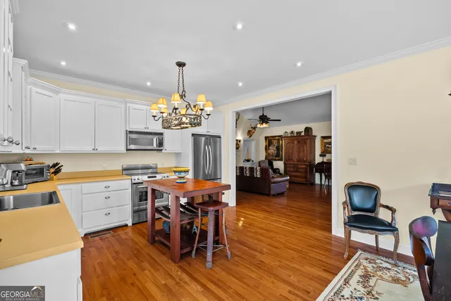 a view of a dining room with furniture and chandelier
