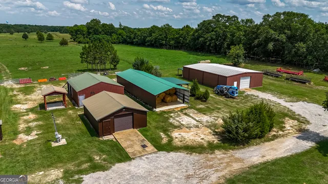 an aerial view of a house with garden space and street view