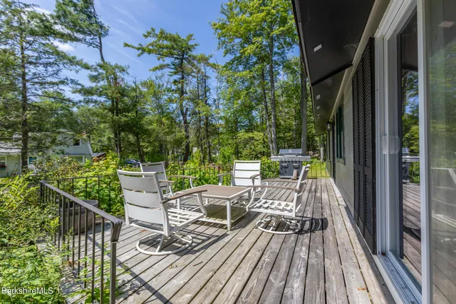 a view of balcony with furniture and wooden floor