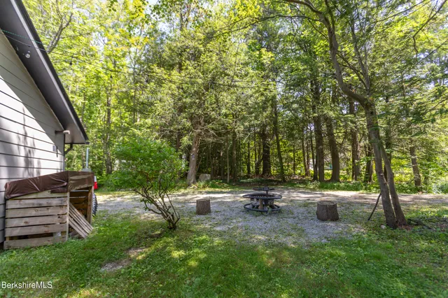a backyard of a house with table and chairs
