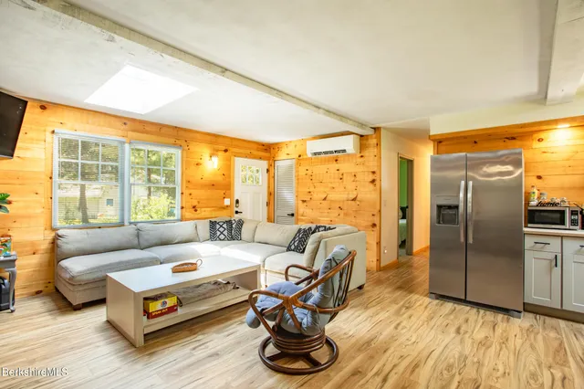 a living room with furniture and a floor to ceiling window