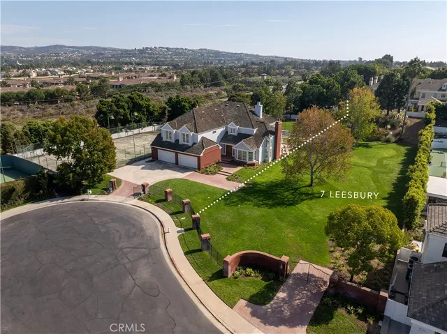 an aerial view of a house with a garden and swimming pool