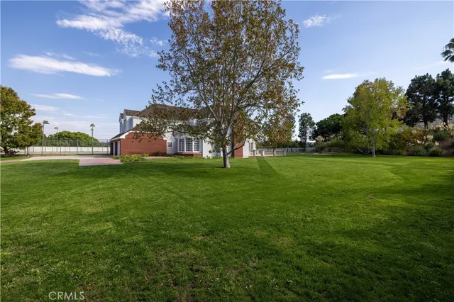an aerial view of a house with a garden and lake view