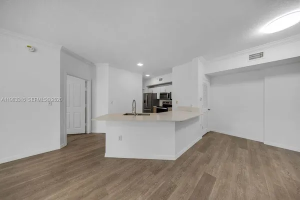 a view of kitchen with kitchen island microwave and stove