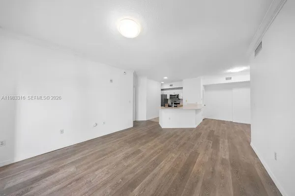 a view of a kitchen with wooden floor and a sink