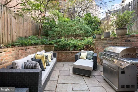 a view of a patio with couches and a fire pit
