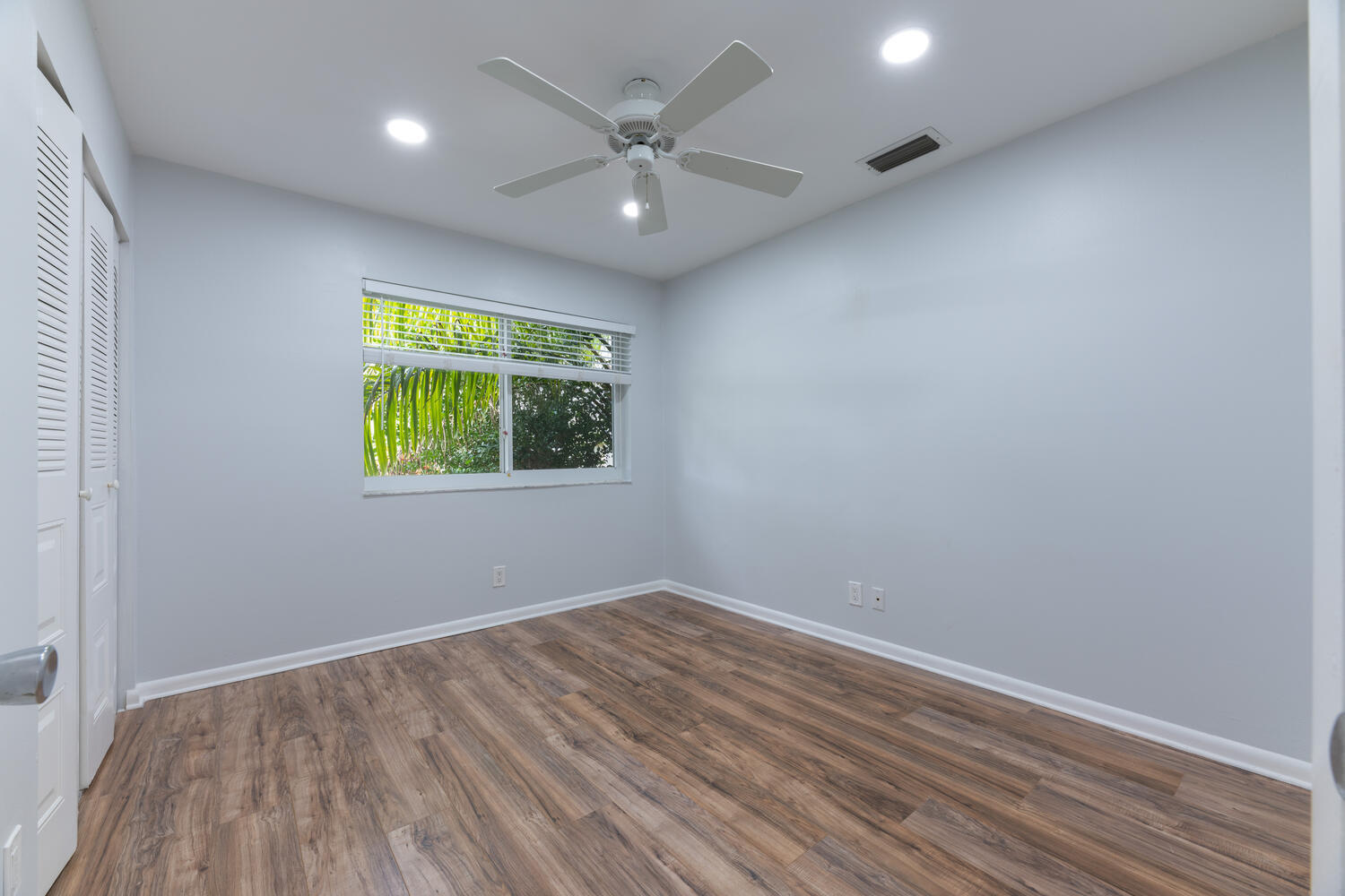 4695 Brandywine Drive Boca Raton, FL 33487 - Photo 14 of 28 an empty room with window and ceiling fan