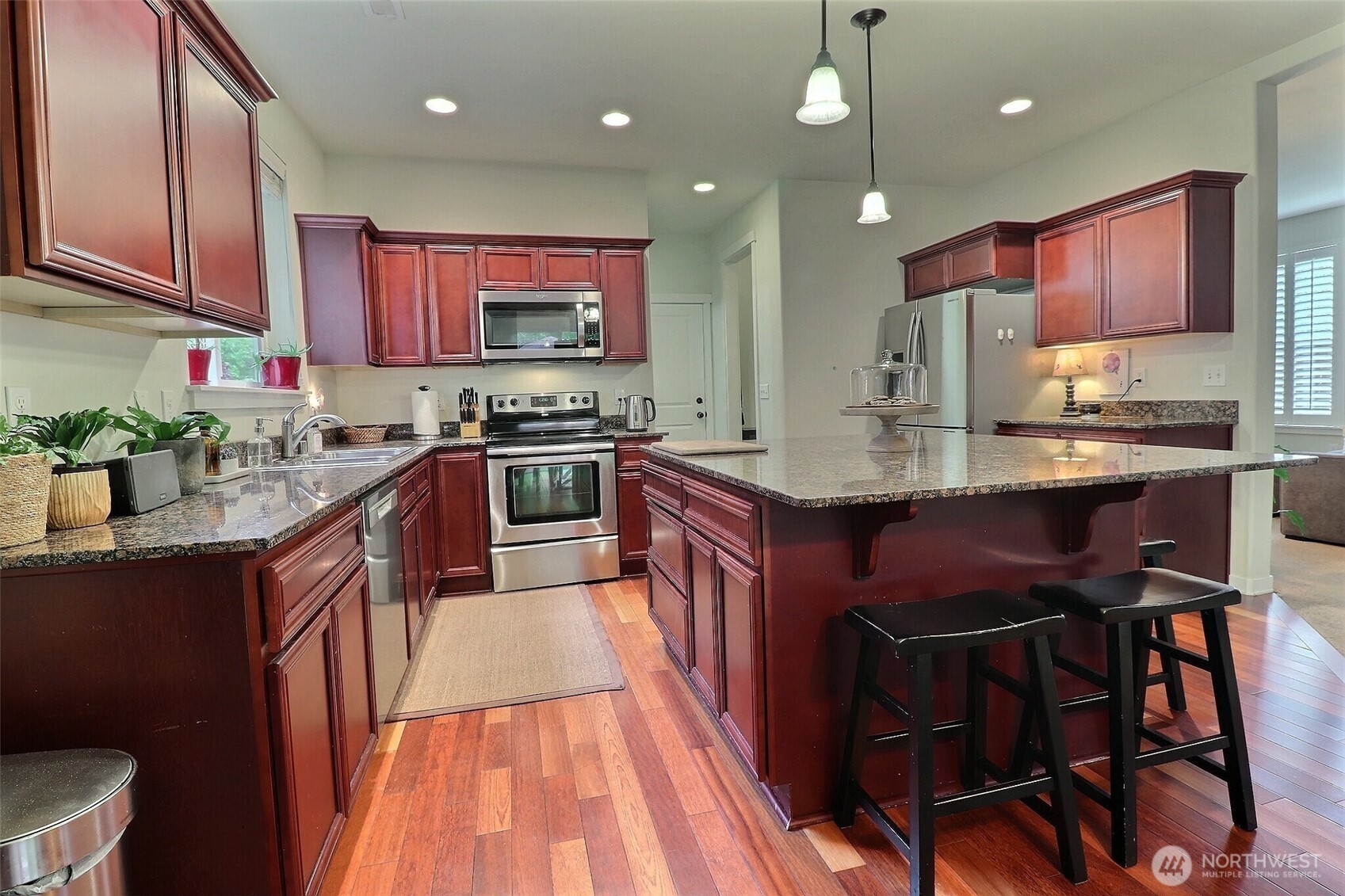 19776 Mountain Ridge Road Southeast Monroe, WA 98272 - Photo 15 of 40 a kitchen with stainless steel appliances granite countertop wooden cabinets a stove top oven a sink and dishwasher