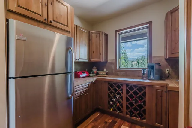 a kitchen with kitchen island a counter top space and a refrigerator