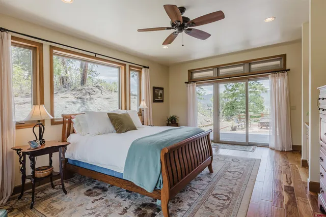 a bedroom with a large bed and a large window