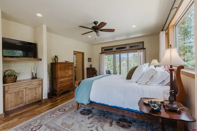 a bedroom with a bed and a flat screen tv