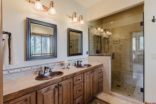 a bathroom with 2 sink and a mirror