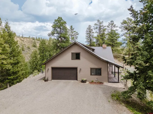 a view of a house with a yard and garage