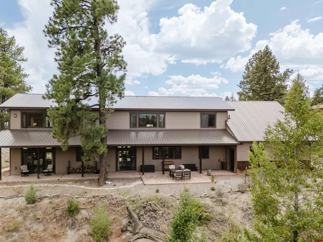 a front view of a house with yard and sitting area