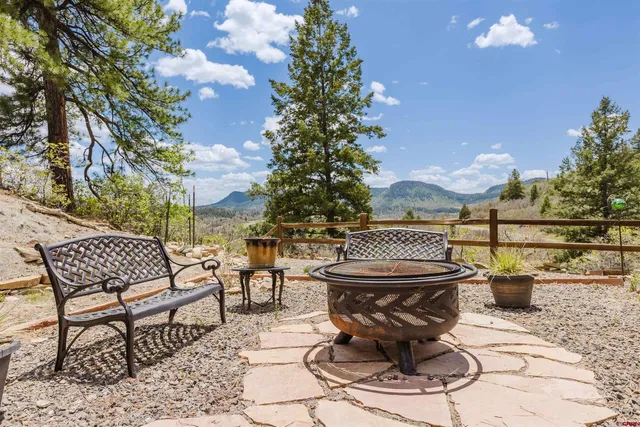 a view of a patio with table and chairs and potted plants