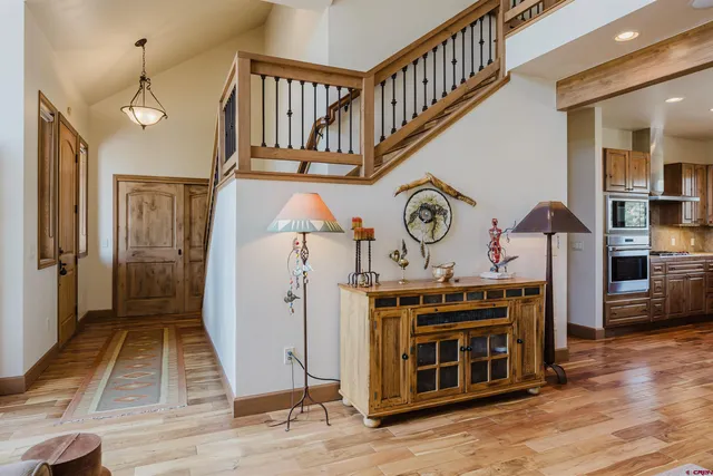 a view of a hallway with entryway wooden floor and front door