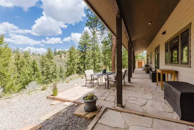 a building outdoor space with patio furniture and potted plants