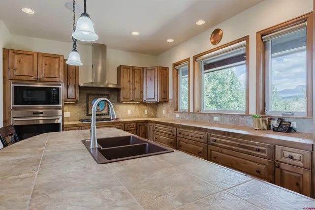 a kitchen with a sink stove and microwave