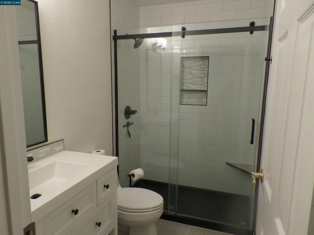 1544 Bailey Road Concord, CA 94521 - Photo 14 of 18 a bathroom with a shower toilet and sink