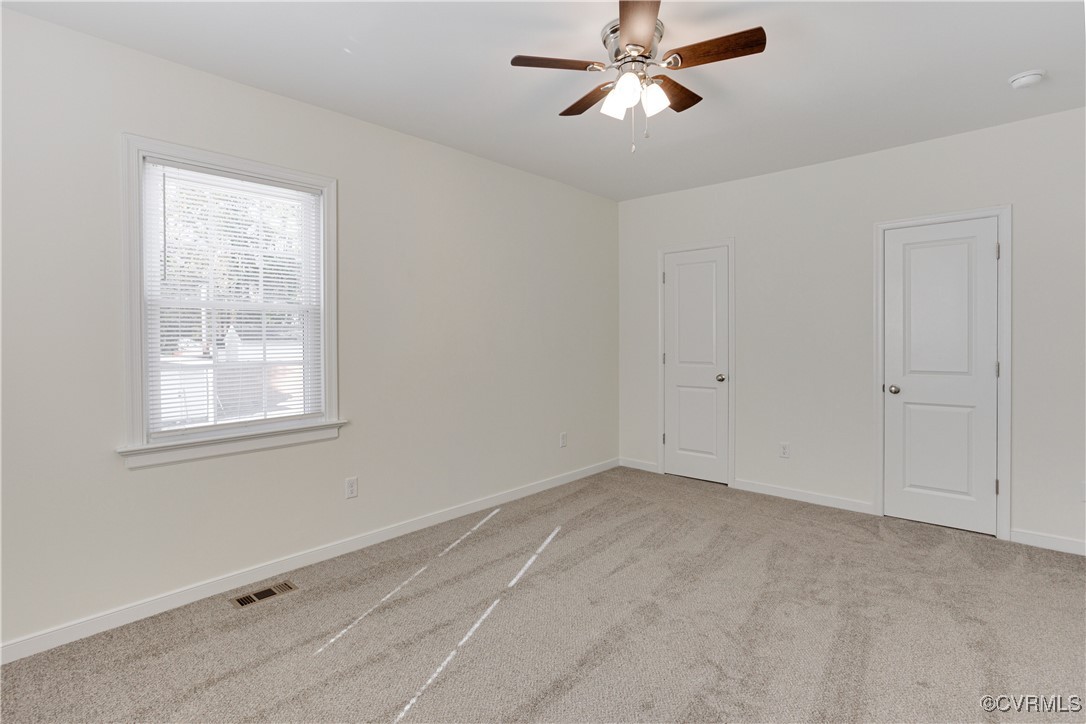 6116 Staples Mill Road Henrico, VA 23228 - Photo 7 of 24 Empty room featuring ceiling fan and light carpet