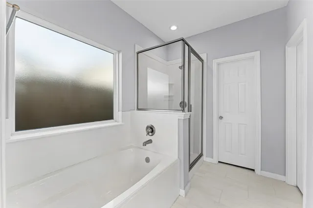 a bathroom with a bathtub and a shower