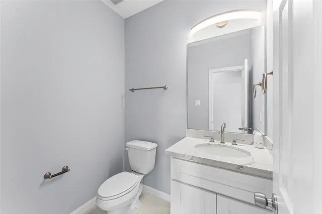 a bathroom with a sink toilet and mirror