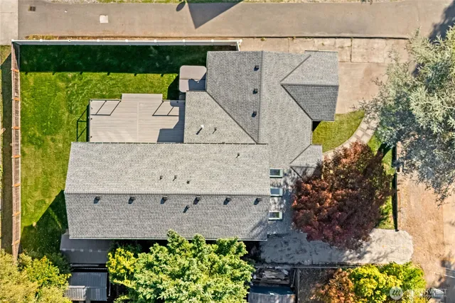 a view of a dining room with furniture a kitchen and chandelier
