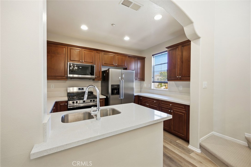 3603 Jetty Carlsbad, CA 92010 - Photo 10 of 43 a kitchen with kitchen island a sink appliances and cabinets