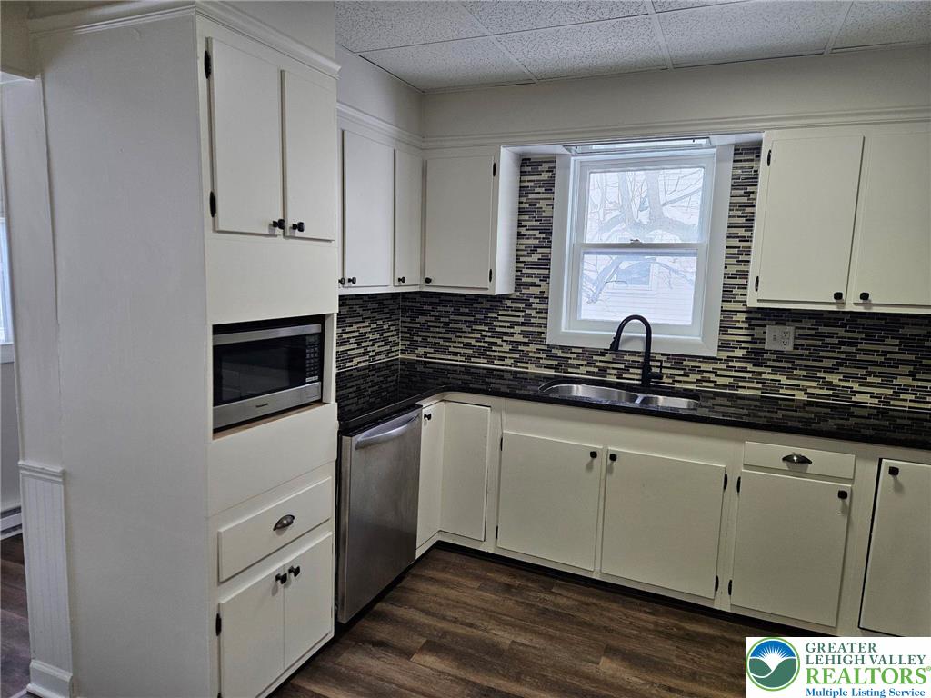 321 Washington Street Walnutport, PA 18088 - Photo 3 of 14 a kitchen with granite countertop white cabinets and sink