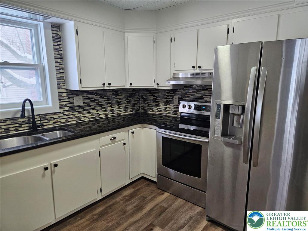 321 Washington Street Walnutport, PA 18088 - Photo 4 of 14 a kitchen with stainless steel appliances white cabinets and a granite counter tops