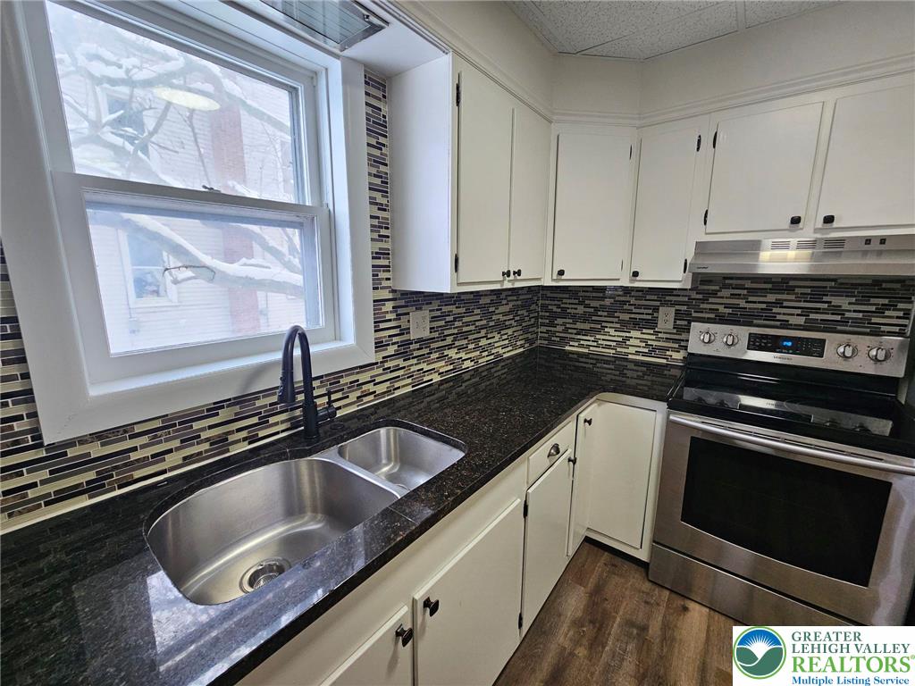 321 Washington Street Walnutport, PA 18088 - Photo 5 of 14 a kitchen with granite countertop a sink stove and cabinets
