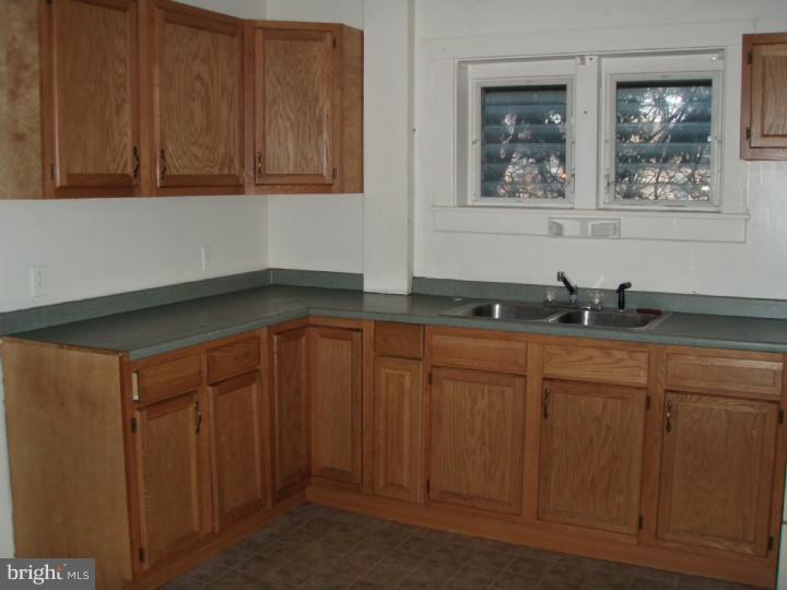 1406 Schuylkill Avenue Reading, PA 19601 - Photo 6 of 8 a kitchen with granite countertop white cabinets and sink
