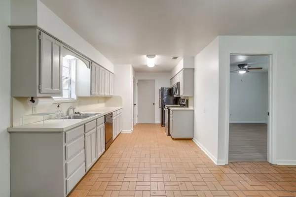 a kitchen with a sink stove and cabinets