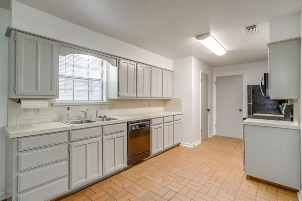 a kitchen with stainless steel appliances a stove microwave and refrigerator