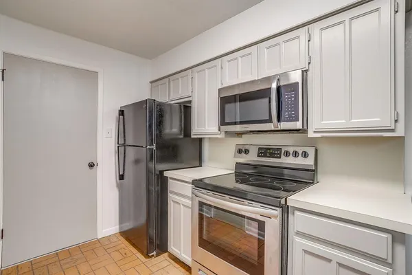 a kitchen with white cabinets
