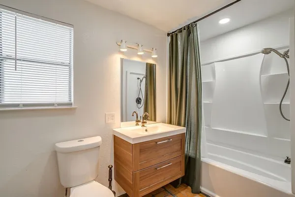 a bathroom with a sink a mirror and a bathtub