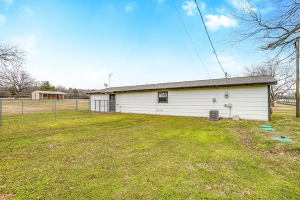 a view of yard with large trees