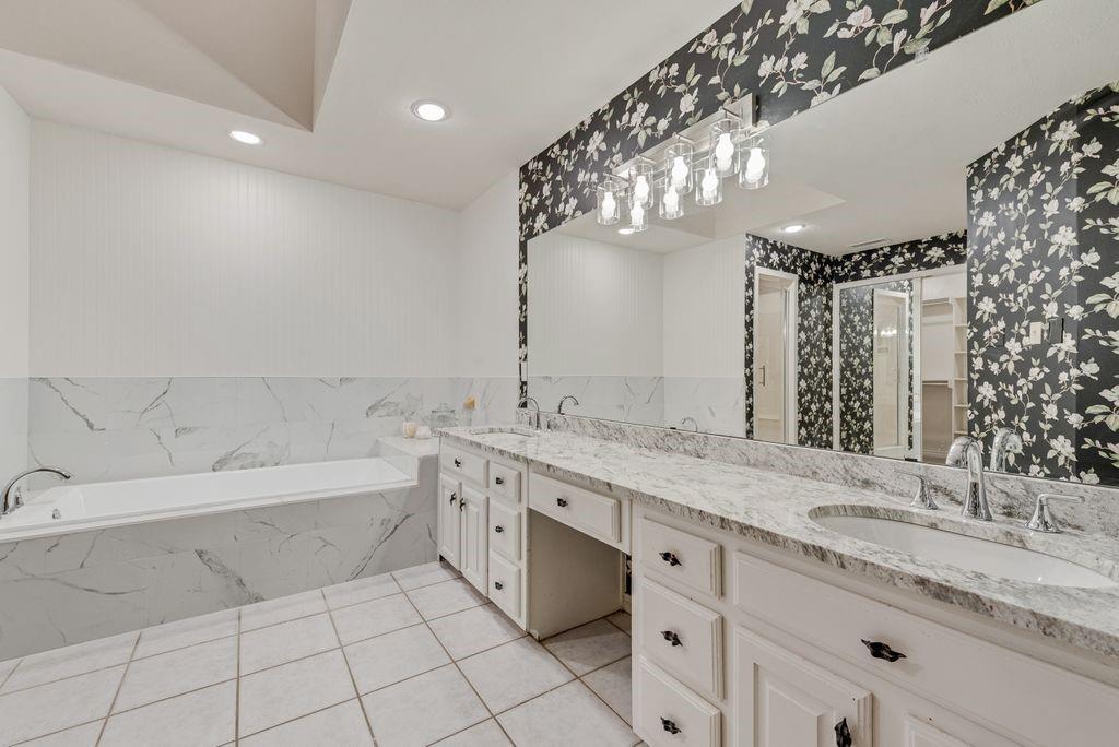 2 Eastshore Road Heath, TX 75032 - Photo 13 of 30 a spacious bathroom with a granite countertop double vanity sink mirror bathtub and shower