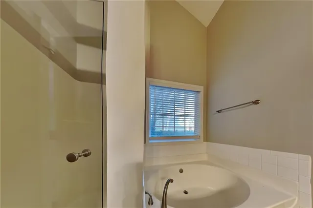 a bathroom with a bathtub and a shower