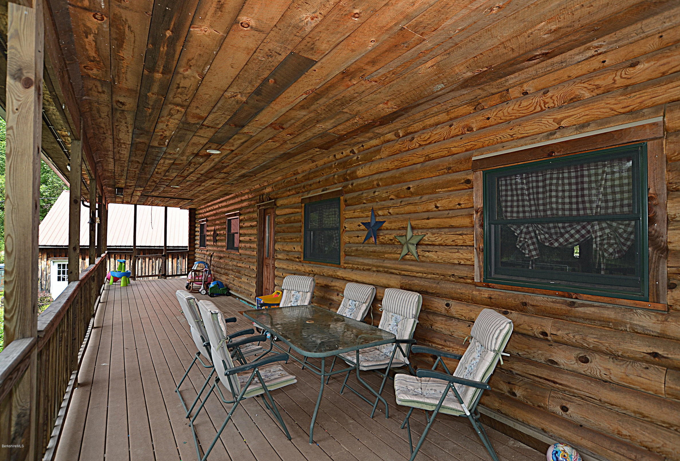 68 Cross Place Road Washington, MA 01223 - Photo 6 of 38 a view of a patio with table and chairs with wooden floor and fence