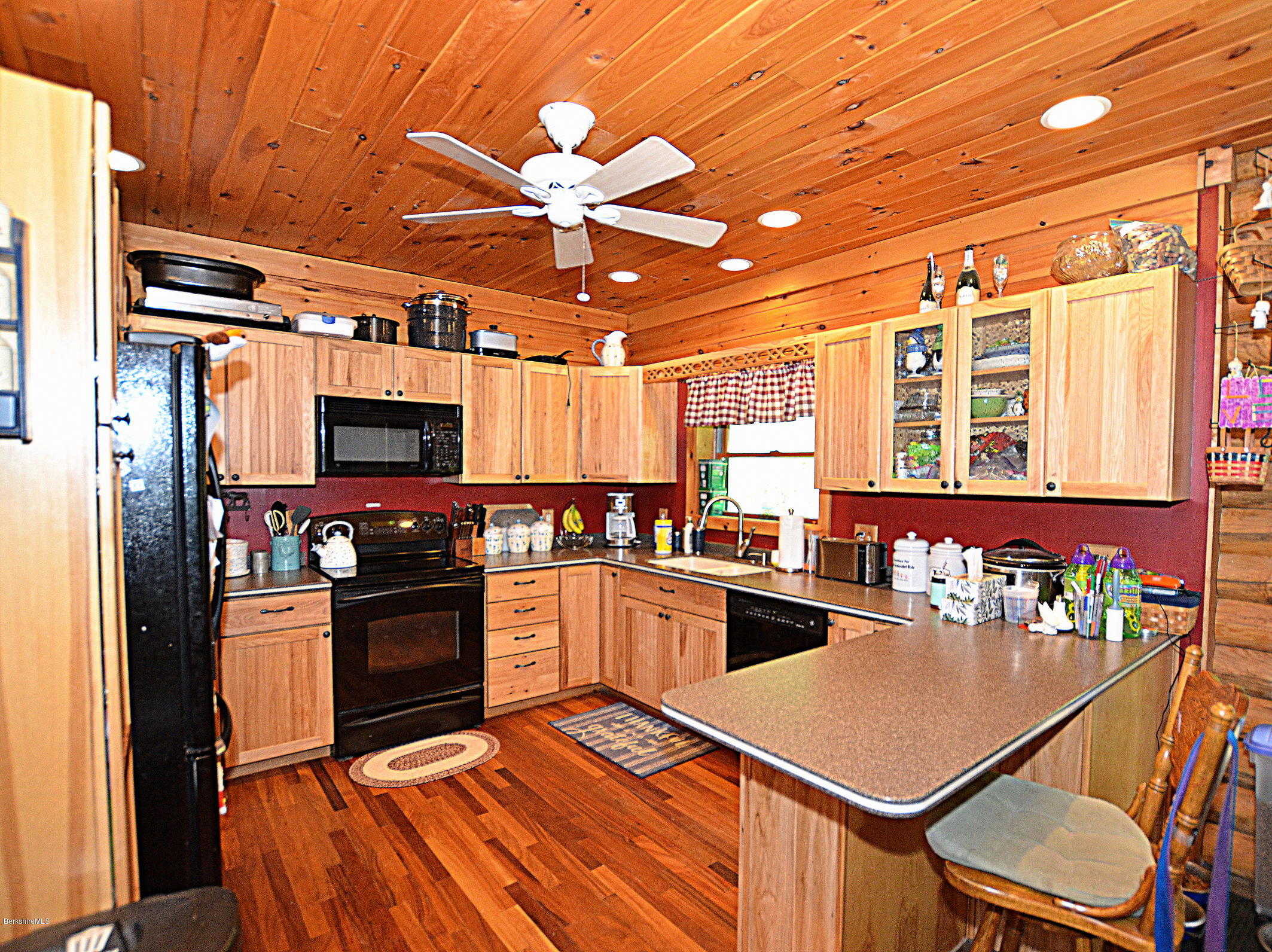 68 Cross Place Road Washington, MA 01223 - Photo 10 of 38 a kitchen with stainless steel appliances kitchen island granite countertop a refrigerator and microwave