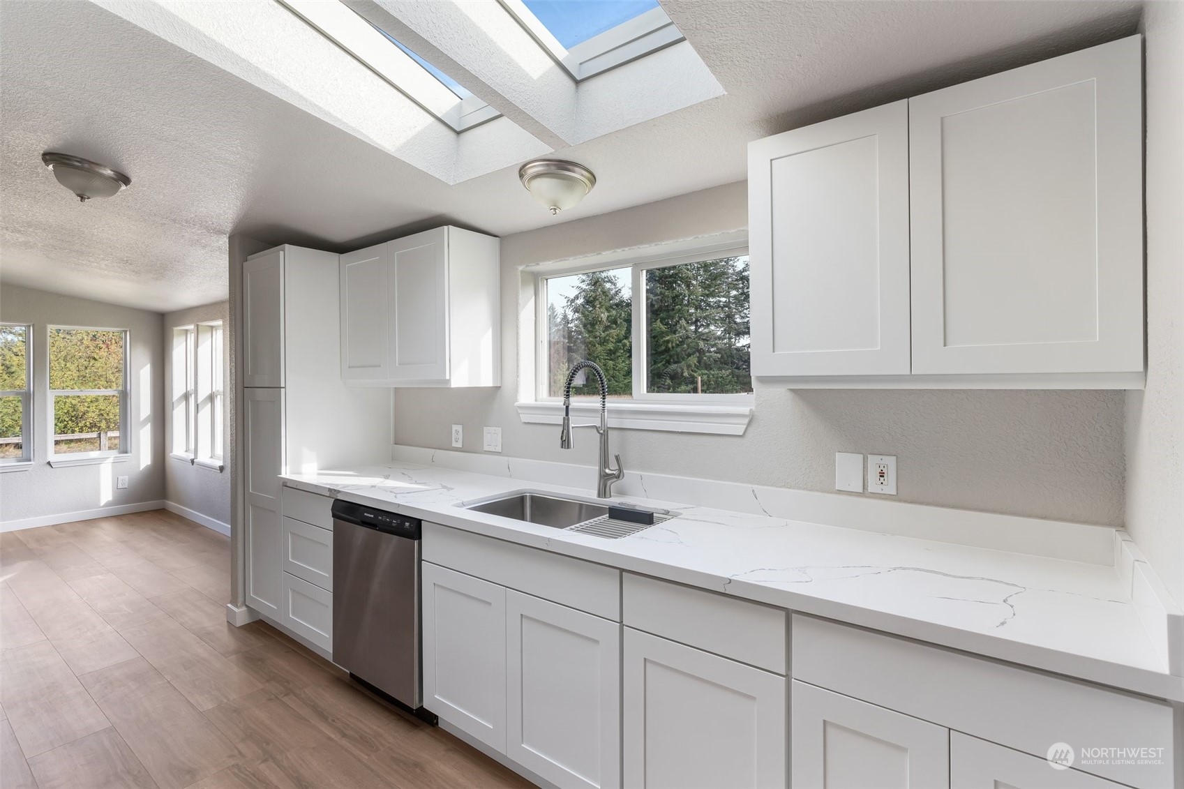 18740 Ivan Street Southwest Rochester, WA 98579 - Photo 11 of 39 a kitchen with a sink cabinets and window