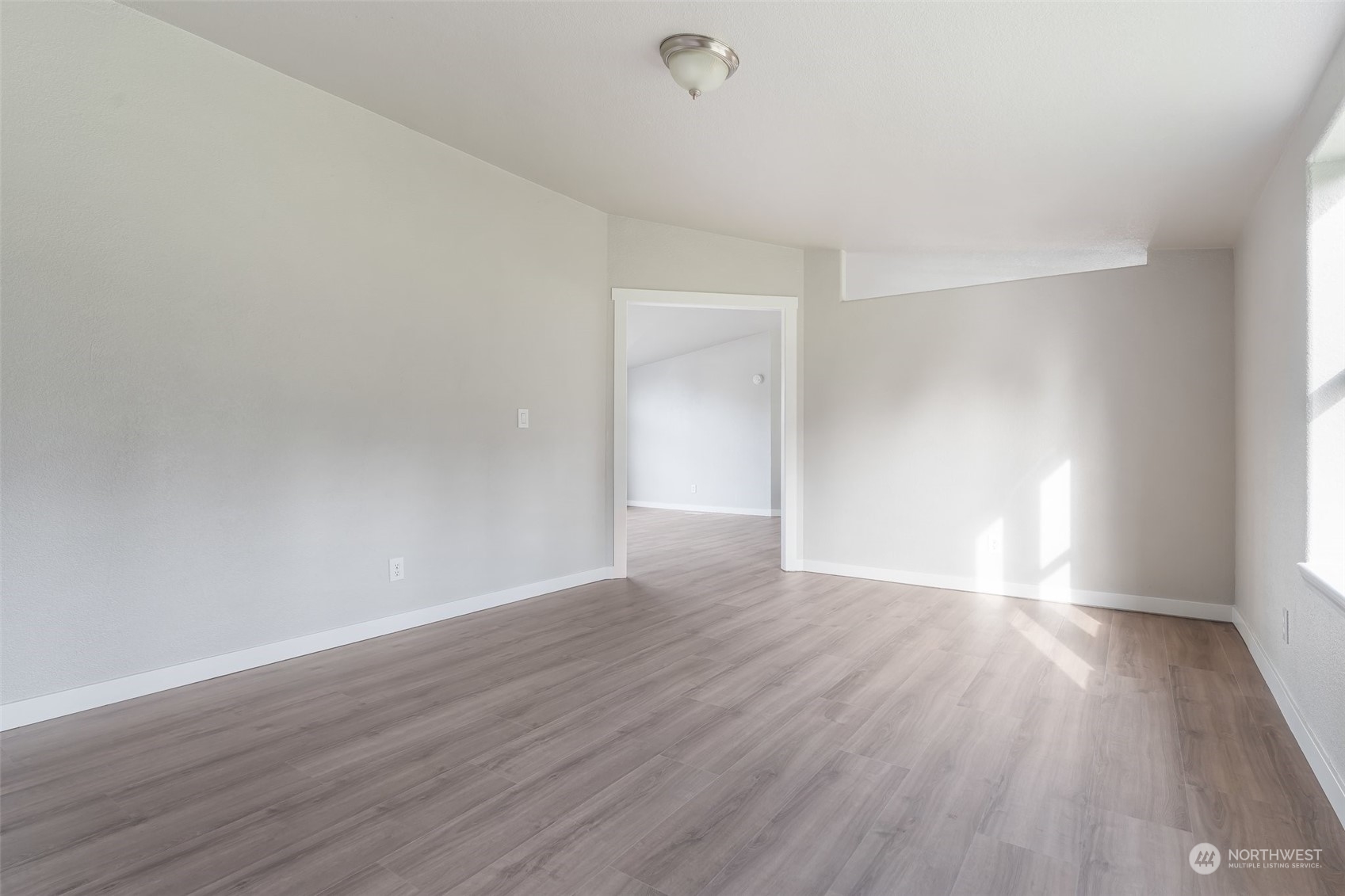 18740 Ivan Street Southwest Rochester, WA 98579 - Photo 14 of 39 a view of an empty room with wooden floor and a window