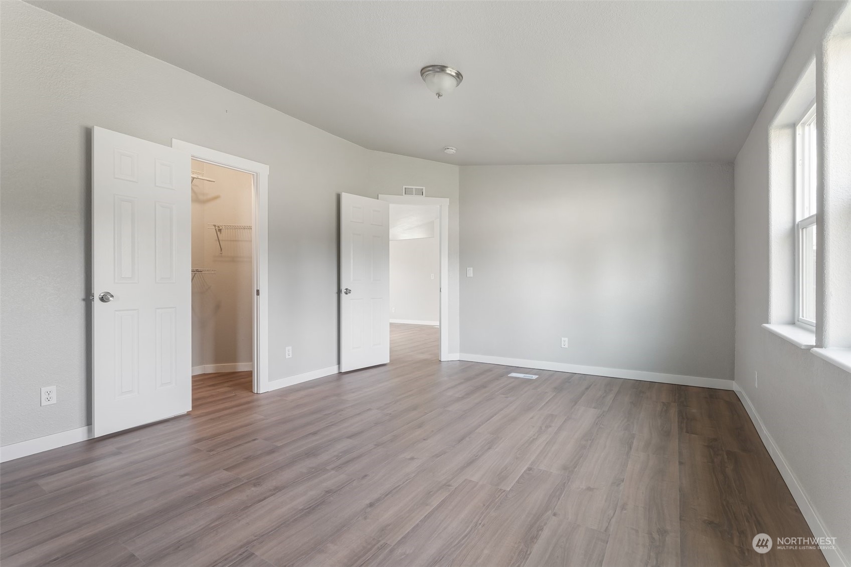 18740 Ivan Street Southwest Rochester, WA 98579 - Photo 17 of 39 a view of an empty room with wooden floor and a window
