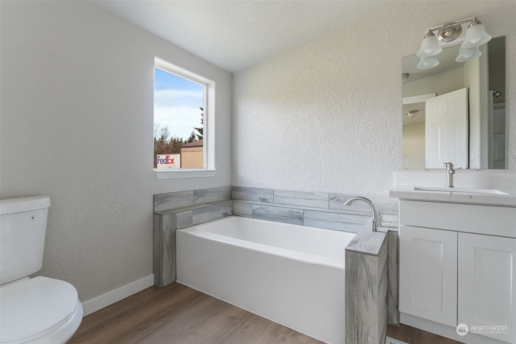 18740 Ivan Street Southwest Rochester, WA 98579 - Photo 19 of 39 a white bath tub sitting next to a white toilet