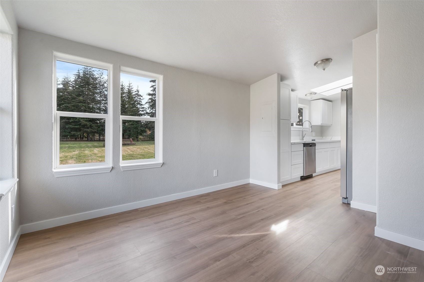 18740 Ivan Street Southwest Rochester, WA 98579 - Photo 24 of 39 a view of an empty room with wooden floor and a window